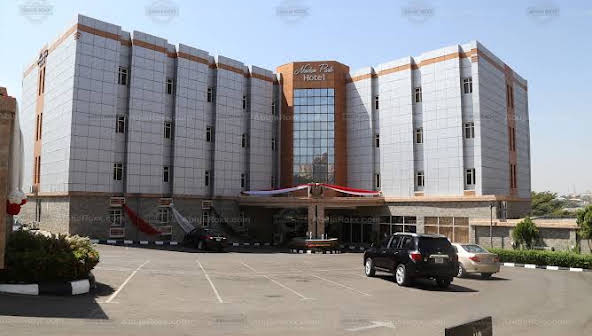 The stone-clad frontage and forecourt of Newton Park Hotel, Abuja
