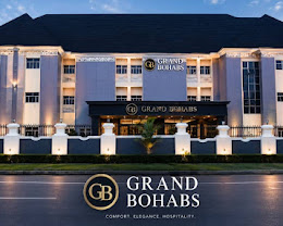 The illuminated evening frontage of Grand Bohabs Hotel, Abuja