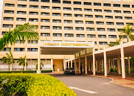 The colonnaded main entrance and driveway of Abuja Continental Hotel