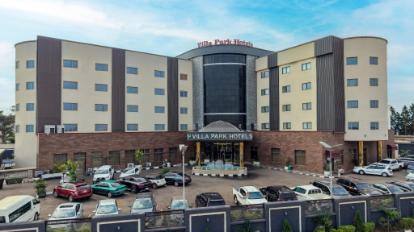 The glass-fronted entrance and forecourt of Villa Park Hotel, Abuja