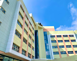 The pastel multi-storey exterior of Lake Greenfield Hotel under a bright sky, Abuja