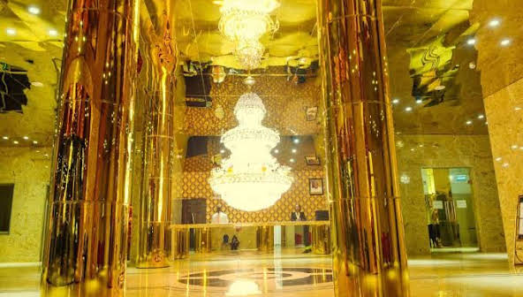 The gold-columned lobby and chandelier at Star View Place Hotel, Abuja