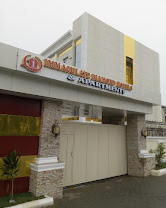 The stone-clad entrance and signage of Immaculate Hotel and Apartment, Abuja